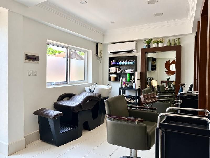 The basin and wash chair beside the styling chairs