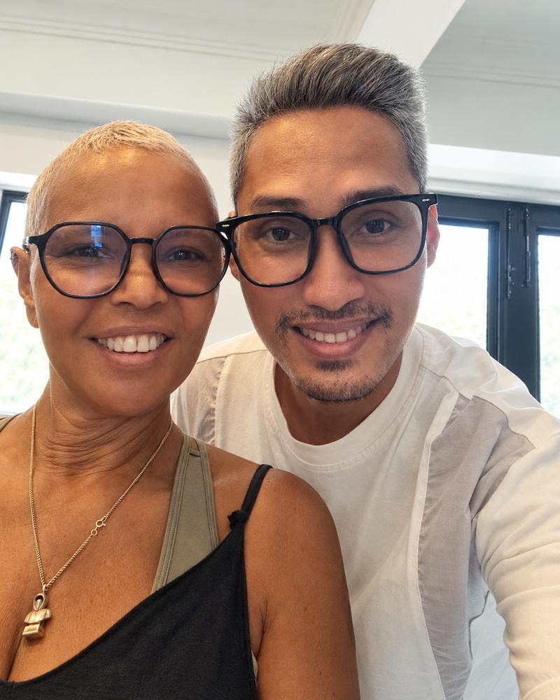 Yanuth beside a client with close-cropped platinum hair
