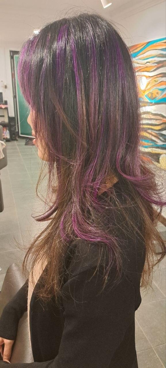 Long dark hair with violet streaks through the lengths